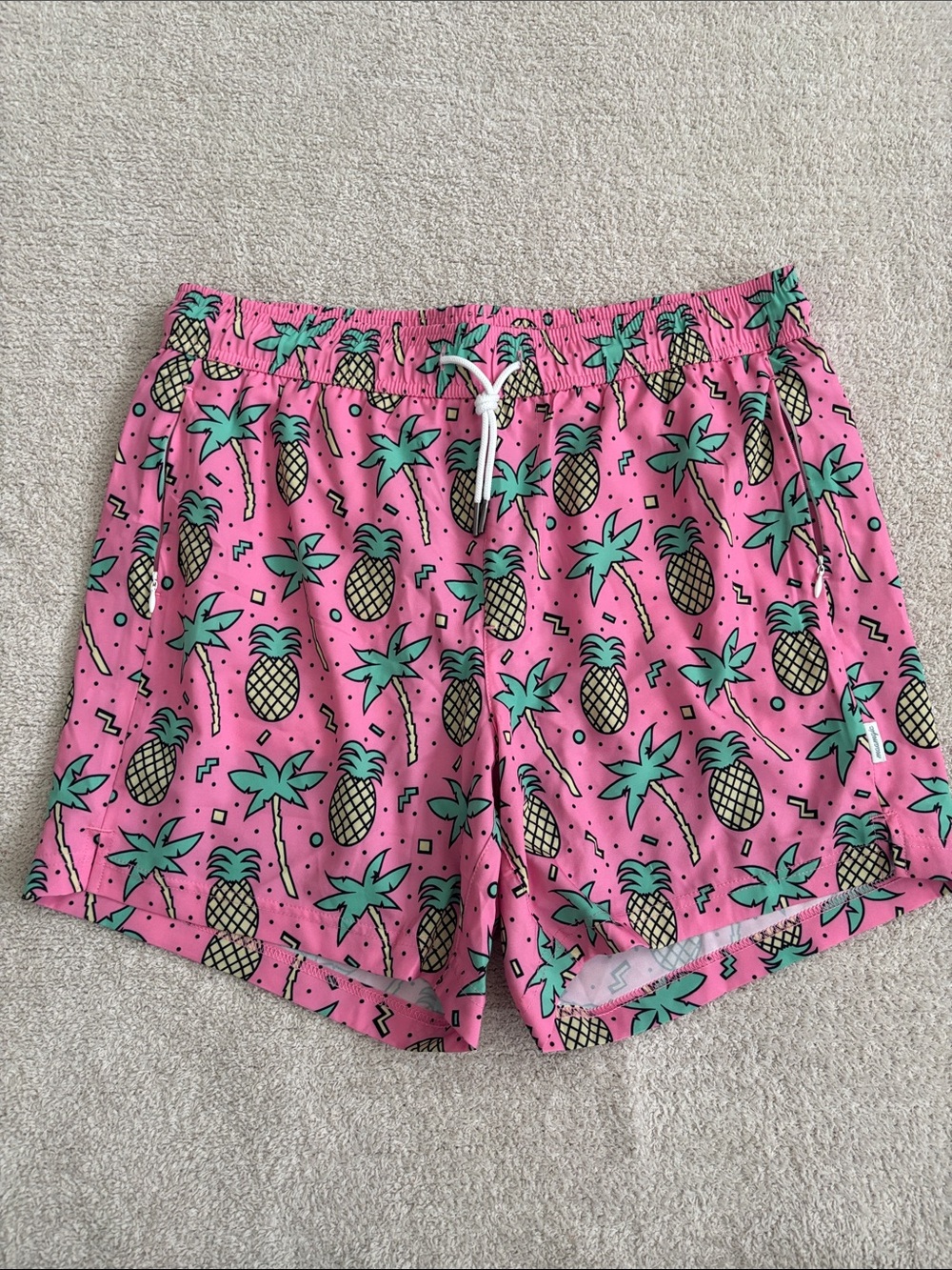 Men’s Pink Pineapple Print Swim Shorts with compression liner.
